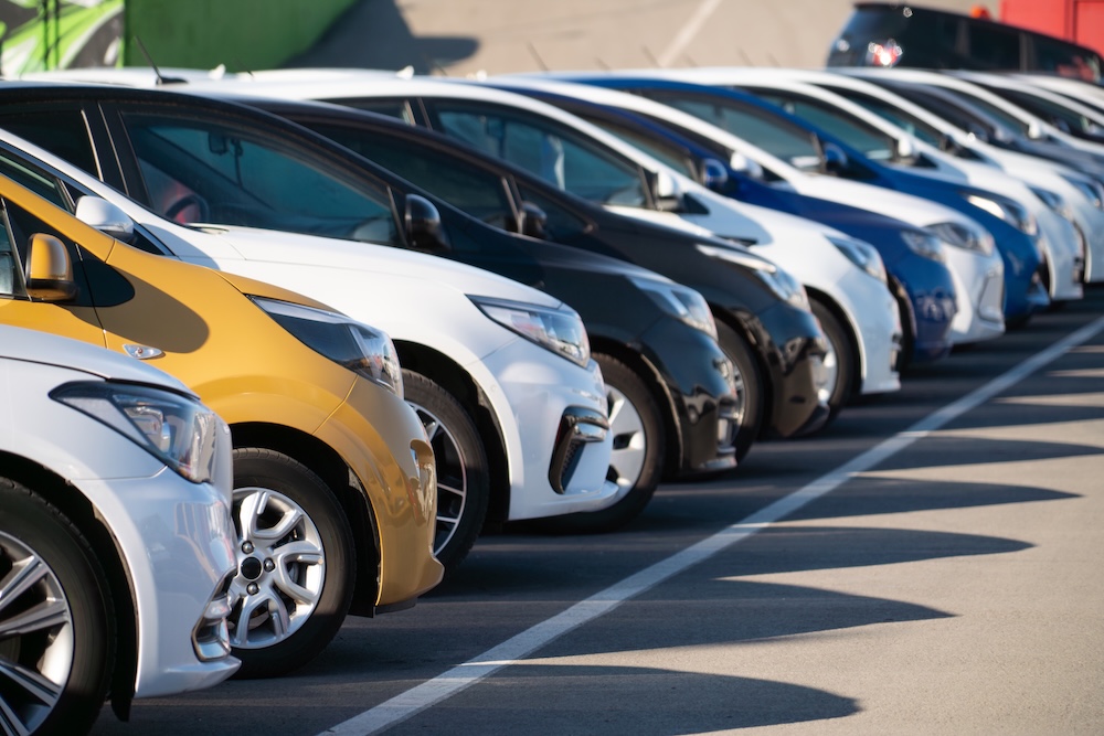 A lot of cars in a rows. Used car sales.