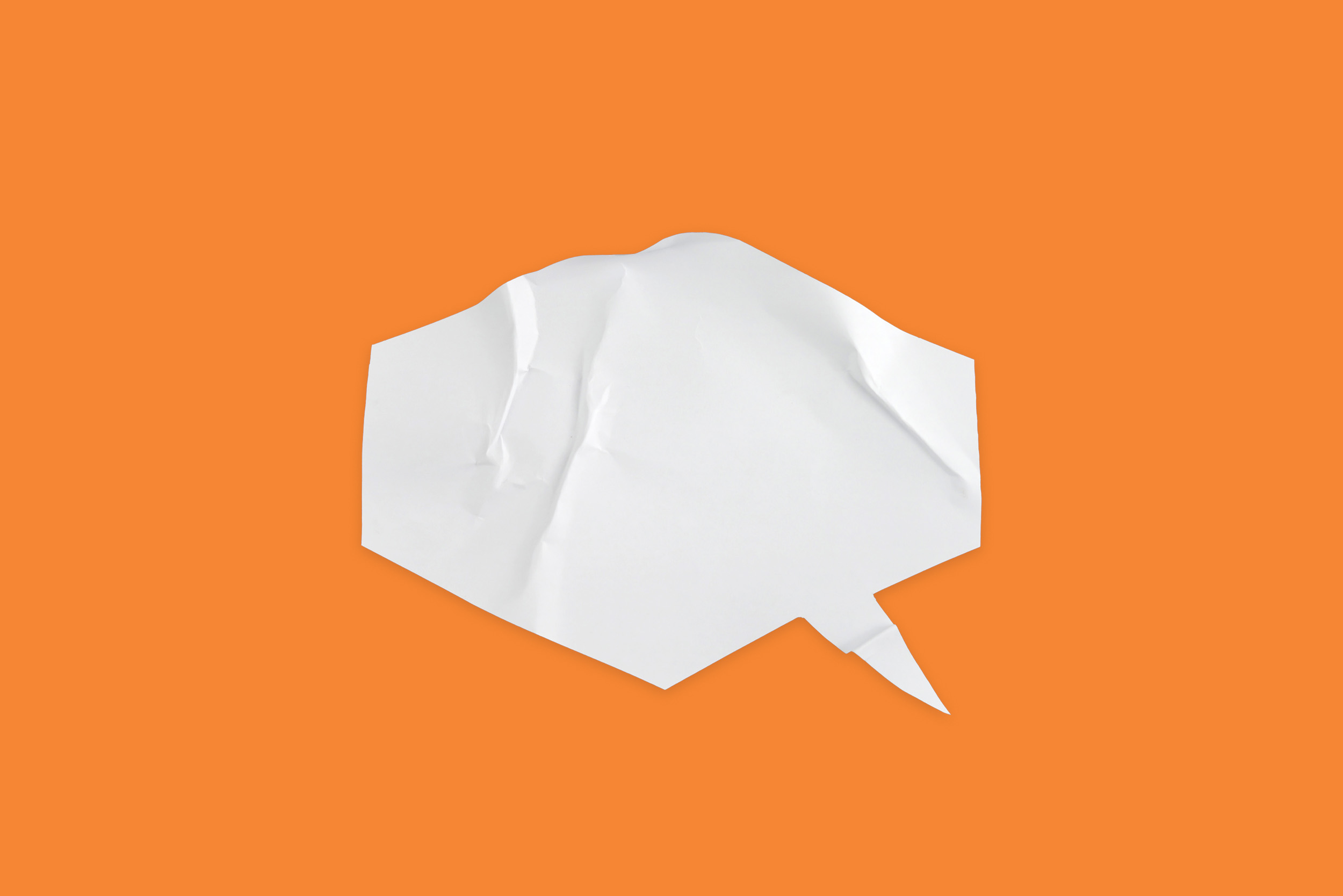 Paper speech bubble against an orange background